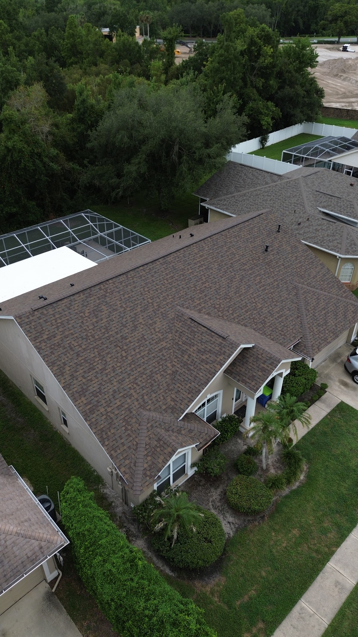 Aerial view of a large brown shingle roof on a home.